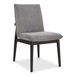 Three-quarter angle of Charlie dining chair showing side profile of padded seat and backrest with dark wood frame