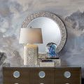 Decorative setup featuring boxes with complementary mother of pearl mirror and lamp on wooden dresser