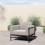 Hearst Outdoor Chair on concrete patio with green plants in background and bright natural lighting