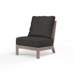 Laguna Armless Club chair with driftwood-finish aluminum frame and dark gray cushions, curved slat back and plank arms
