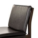 Side view emphasizing sleek frame lines and leather upholstery profile on chair