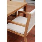 Outdoor setting featuring partial view of chair beside teak dining table on terracotta tile flooring
