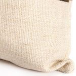 Detailed close-up of beige linen fabric texture on lower pillow portion