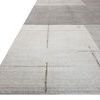 Angled view highlighting low pile texture and surface detail of grey and olive geometric rug