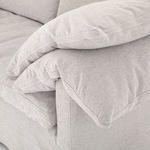 Close-up of plump pillow corner and seat cushion showing detailed stitching and padding texture