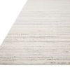 Angled view showing low pile and woven fiber texture of ivory and dove striped rug