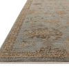 Close-up angled view showing rug’s low pile texture and detailed border pattern