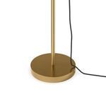 Detailed view of lamp's round brass base with power cord resting beside it