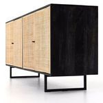 Side view showing black mango wood panel and angular gunmetal legs of Carmel Cane Sideboard