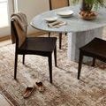Dining area staged on Sorrento Mocha rug with tableware and house slippers on floor