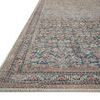 Close-up angled view showing detailed edge stitching and fine weave of multi-patterned rug