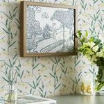 Wallpaper installed on wall with framed deer artwork and decorative flowers on a table beneath it