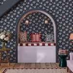 Wallpaper applied in cozy alcove with arched entrance, wooden floor and patterned cushions