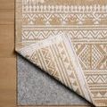 Rug corner flipped showing durable backing and reversible pattern with ivory and wheat colors