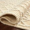 Rolled edge of Noelle Ivory Gold Rug showing thickness and combination of smooth and bobble texture
