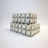 Side angled view of stacked boxes highlighting uniform bone cube relief and texture