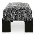 Priya bench end view highlighting thick boucle upholstery and glossy black iron legs