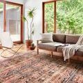 Layla Mocha / Blush rug styled in bright room with modern beige sofa and natural wood floors