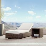 Montecito Chaise placed outdoors on patio with a side table and mountain view in background