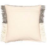 Back of pillow in solid cream fabric with envelope closure and tasseled edges visible
