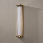 Wall sconce mounted on textured beige wall casting soft shadow
