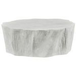Side view of white matte tree trunk coffee table showcasing uneven edge and textured surface
