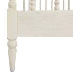 Close-up of turned tapered leg and side rail joint in distressed white finish on Jennifer Twin Bed