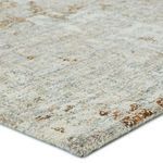 Close-up corner view showing hand-tufted wool and viscose texture with light neutral tones and bronze speckles