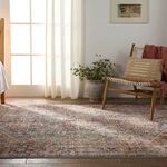 Natural sunlight falling on Zakaria rug in a room with a wooden chair and ceramic planter