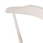 Close-up focusing on sheepskin cushion softness against wooden frame edges