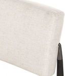 Close-up showing stitching and padding on top corner of chair’s backrest