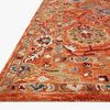 Close-up side angle showing thick hooked wool texture and intricate border details in orange and multicolor