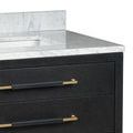 Close-up of vanity showing black linen drawer texture, gold handles, and Carrara marble countertop edge