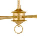 Close view of chandelier's central hub showing petite ring and aged gold texture