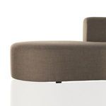 Sectional base close-up emphasizing curved bottom edge and fabric texture