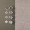 Top-down view of wallpaper placed next to open paint cans with neutral color swatches