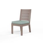 Laguna Armless Dining Chair in driftwood-like aluminum frame with horizontal slats and light teal cushion