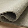 Polly Spa rug rolled to reveal wool and jute pile thickness and flexible backing