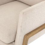 Macro shot focusing on armrest seam, fabric texture, and wood frame intersection