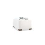 Rear view of single sectional piece with textured white chenille fabric and dark wood base