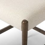 Close-up on angled seat corner and round wood post