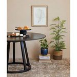 Solaris Round Dining Table styled with decorative tray and plants in a cozy dining room setting