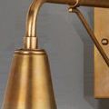 Close-up of polished antique brass conical top and curved arm of Mariner Outdoor Wall Sconce