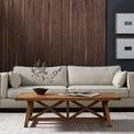 Trellis Coffee Table styled in living room with beige sofa, book, decorative bowl, and textured wooden panel wall