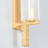 Close-up of hand-carved horizontal grooves on gold leaf textured rod near bottom of sconce