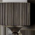 Close-up of oil-rubbed bronze base showing vertical ridged industrial gear pattern and round finial
