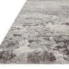 Low angled close-up highlighting thick plush pile and texture variation in grey tones