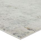 Close-up of rug corner showing thin edging and high-low textured pile