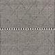 Sawyer Black Rug with bold black and white geometric diamond pattern and fringe on ends