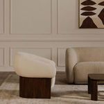 Otto accent chair side profile styled in muted-tone room with rug and sofa in background